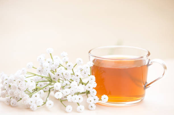 istock Autumn tea. Marigolds and tea cup autumn background 1173830161