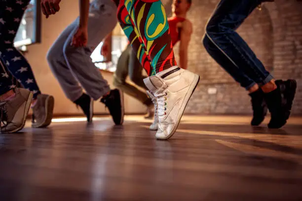 Photo of young modern dancers dancing in the studio. Sport, dancing and urban culture concept