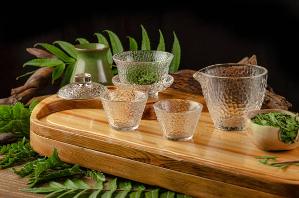 tea table with instruments teapots cups pancake and tea Shen Puer the tea table with instruments teapots cups pancake and tea Shen Puer tao of herbs pictures stock pictures, royalty-free photos & images