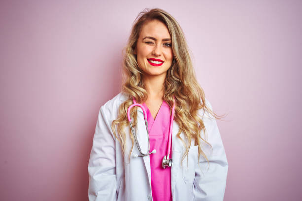 istock Young beautiful doctor woman using stethoscope over pink isolated background winking looking at the camera with sexy expression, cheerful and happy face. 1173835742