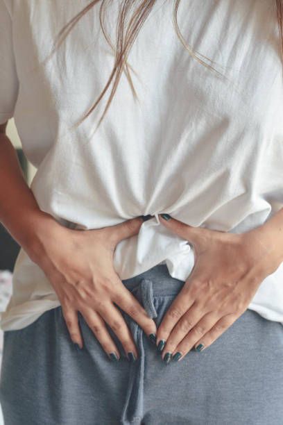 istock Young woman suffering from pain, sick in bed 1173839937