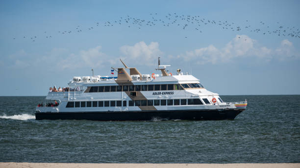 Amrum Adler Express boat Amrum, Germany - August 25, 2019: Adler Express boat close to the coast north of Amrum amrum stock pictures, royalty-free photos & images