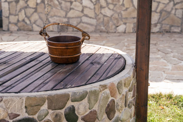 a beautiful traditional well. - well fountain water pipe pipe imagens e fotografias de stock