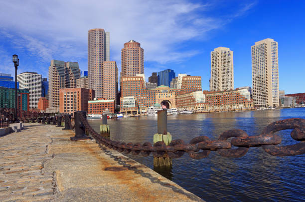 istock Boston skyline with skyscrapers reflections into the ocean and rusty chain on the foreground 1173841597