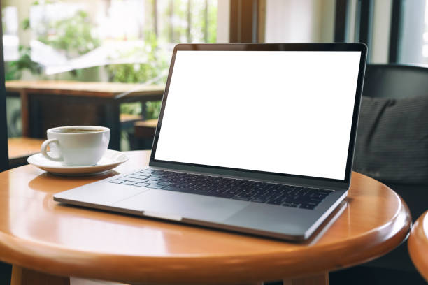 istock laptop computer with blank white desktop screen with coffee cup on wooden table 1173843413