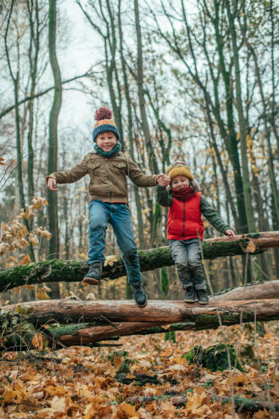 istock Happy children enjoying autumn in forest 1173845919