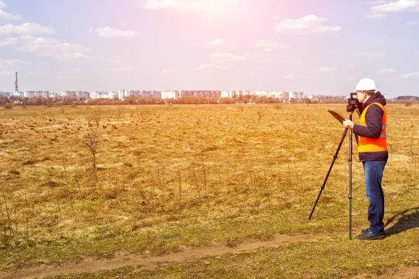 Surveyor worker measures the distance and length using measuring equipment for the construction of a new micro district, copy space, Angle measurement, geodesy