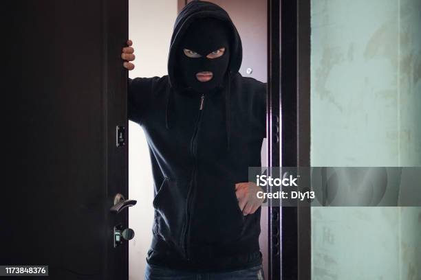 Evil Threat To Rob Broke Into Private Ownership Breaking Into An Apartment Maniac Went Into The House The Concept Of Crime And Violence Gun Or A Knife In Your Pocketopen Door To A Stranger Stock Photo - Download Image Now