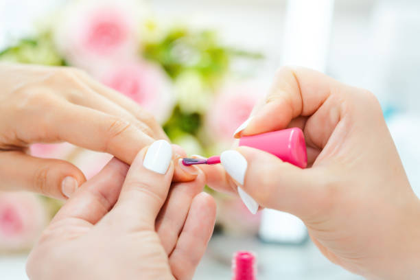 istock Experienced nail technician applying nail color 1173848810