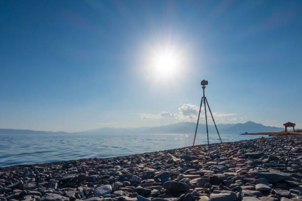 istock Camera on Tripod Taking Pictures of Lake 1173854628