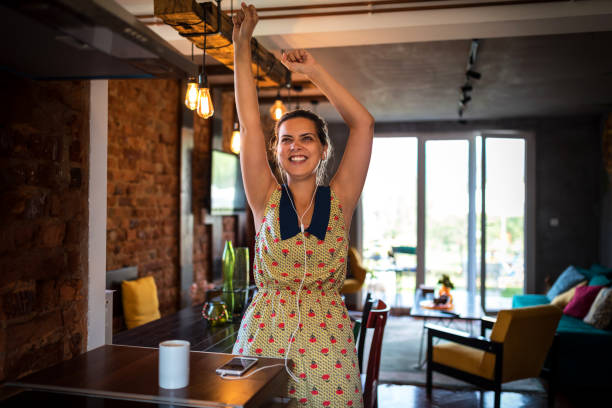 istock Happy young woman dancing in the kitchen 1173855105