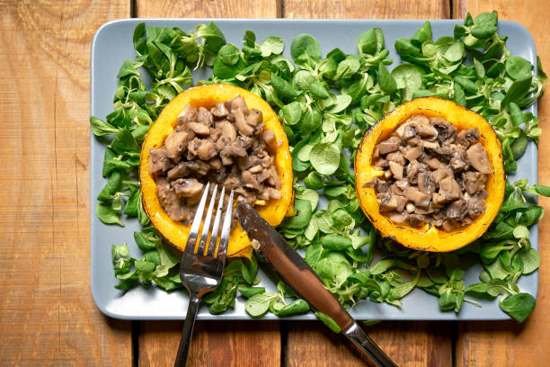 istock Peppers stuffed with champignons with lettuce on wooden table 1173862620