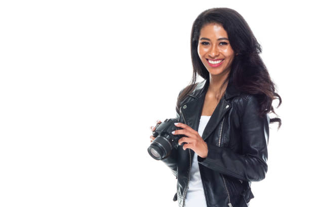 istock Bautiful woman wearing a leather jacket sitting and using a DSLR camera 1173864496