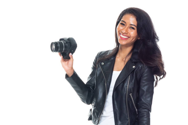 istock Bautiful woman wearing a leather jacket sitting and using a DSLR camera 1173865031