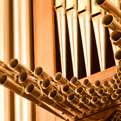 Metallic organ pipes close-up. The image was captured in a baroque church built in 1778.