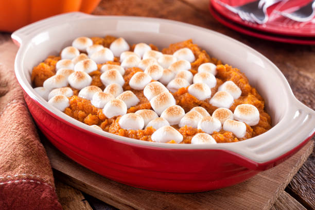 Sweet Potato Casserole A delicious homemade sweet potato casserole with marshmallow topping. candied fruit stock pictures, royalty-free photos & images