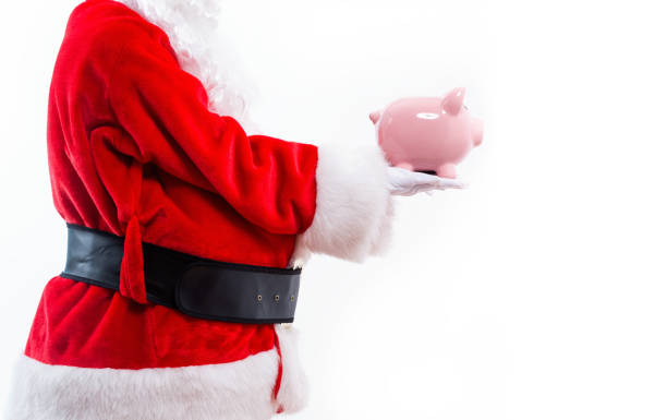 istock Santa holding a piggy bank 1173881180