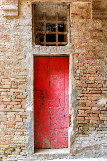 istock Old red door to a house 1173881210