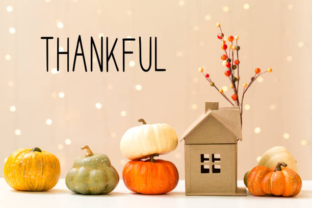 Thankful message with pumpkins with a house stock photo