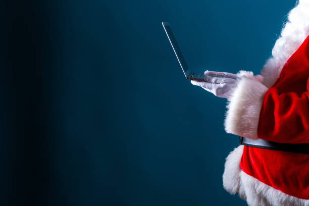Santa using a laptop stock photo