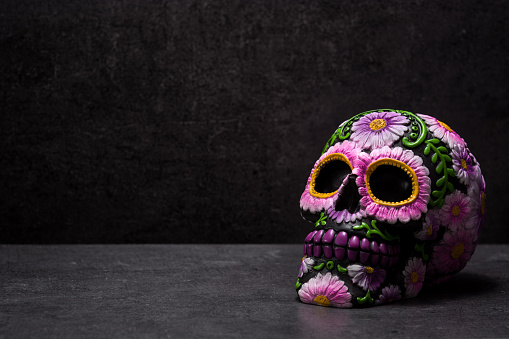 Typical Mexican skull painted on black background. Copyspace. Dia de los muertos.