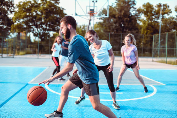 istock Friends Playing Basketball Together 1173884896