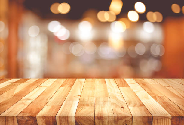 istock Wood texture table top (counter bar) with blur light gold bokeh in cafe,restaurant background 1173888454