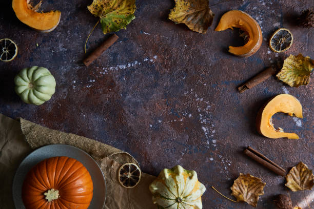 istock Pumpkin with leaves, vanilla. Autumn cozy background Dark background 1173894079