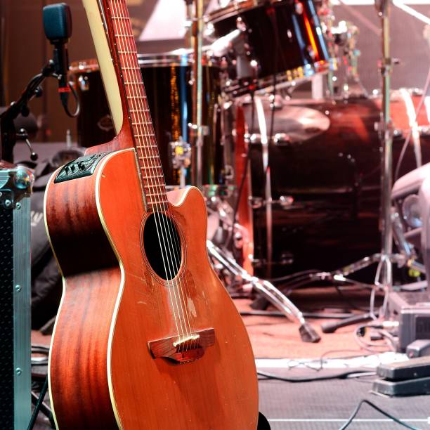 istock Guitar and other musical equipment on stage before concert 1173895199