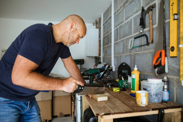istock Woodworker Sawing Wood 1173896567