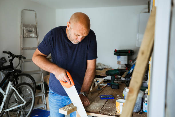 istock Carpenter Sawing Wood 1173896843