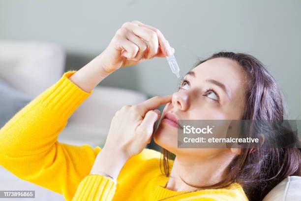Closeup View Of Young Woman Applying Eye Drop Artificial Tears Stock Photo - Download Image Now
