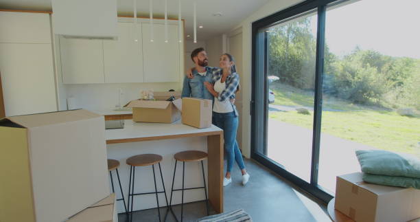 istock Couple Carrying Boxes Into New Home On Moving Day. 1173896951