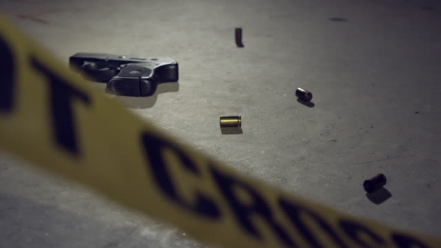 Police Crime Scene Tape with Handgun and Bullets