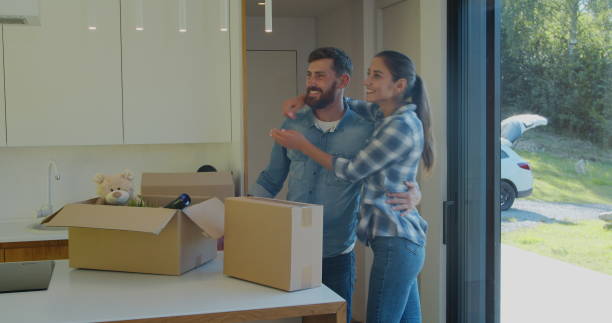 istock Couple Carrying Boxes Into New Home On Moving Day. 1173897074