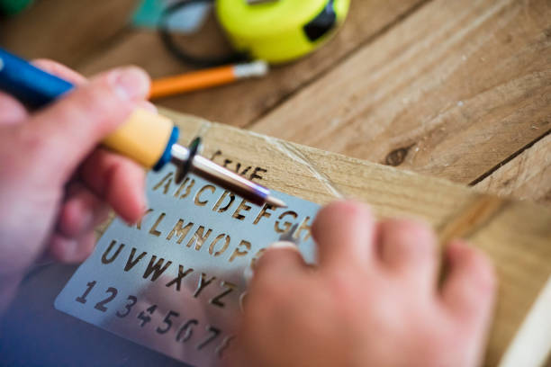 Using A Wood Burning Tool And Stencil Stock Photo - Download Image Now -  Stencil, Engraving, Alphabet - iStock