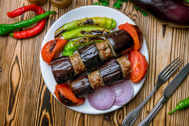Turkish Kebab eggplant and meatballs on wooden table stock photo