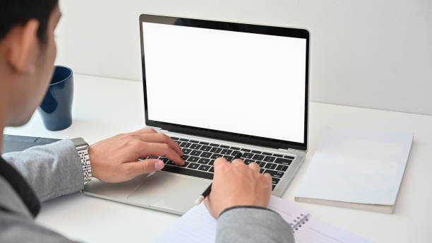 istock Behind shot businessman using isolated screen of laptop computer on desk. 1173909508