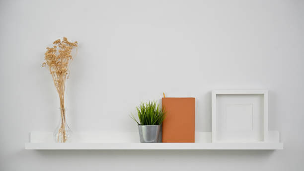istock Dry flower, plant, notebook and photo frame on Shelves. 1173909527