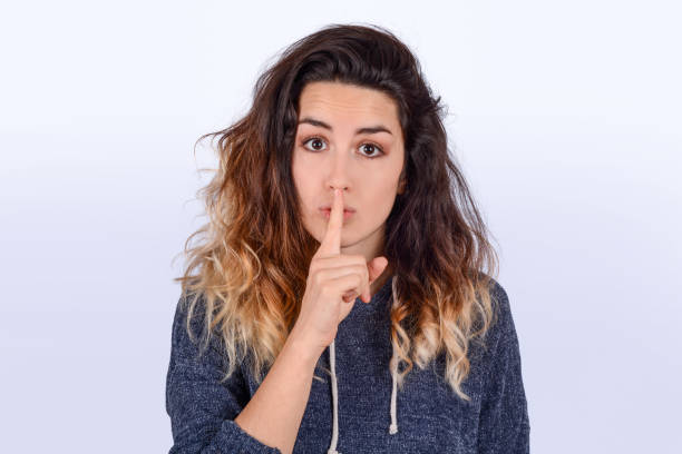 istock Close up of young woman making silence gesture. 1173909589