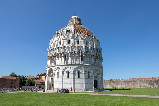 Pisa, Italy - June 29, 2018: Panoramic view of exterior of Pisa Baptistery of St. John (Battistero di San Giovanni) is a Roman Catholic ecclesiastical building in Pisa