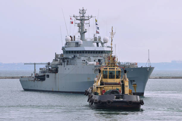 istock Tugboat and warship 1173914872