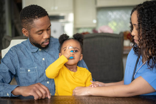 istock Girl at doctor's appointment using an asthma inhaler 1173915178