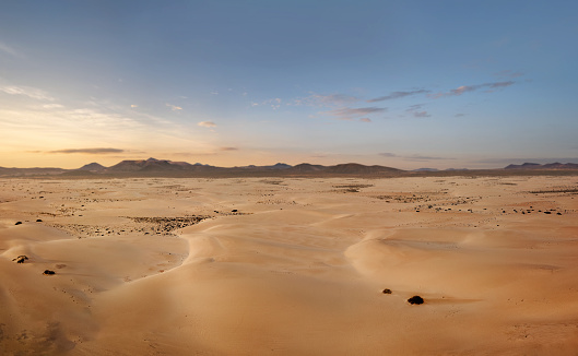 High angle, panoramic view of an empty desert at the sunrise with copy space