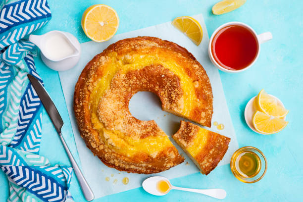 istock Lemon bundt cake with cup of tea. Blue background. Top view. 1173919103