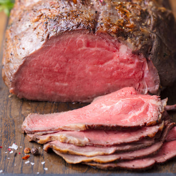 istock Roast beef on cutting board. Wooden background. Close up. 1173919257