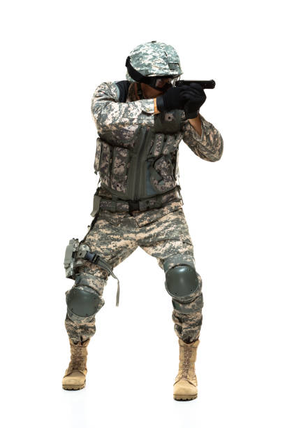 front view of armed forces / army soldier / hero standing in the army / military / us military wearing military uniform / uniform / glove who is serious / confidence / concentration and showing patriotism and holding usa / weapon - 16710 imagens e fotografias de stock