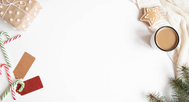 istock Christmas or New Year composition with presents, candy canes, coffee mug and gingerbread cookies on white background. 1173922330