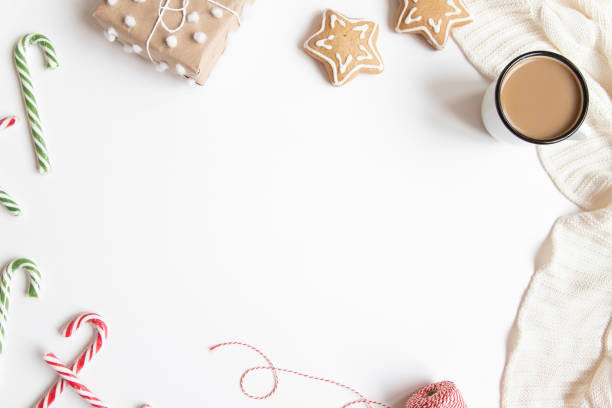 istock Christmas or New Year composition with presents, candy canes, coffee mug and gingerbread cookies on white background. 1173922365