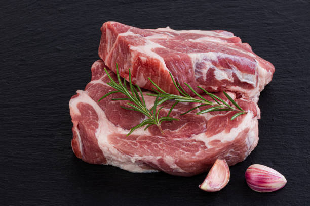 istock Raw meat,  steak with spices on black background 1173923283